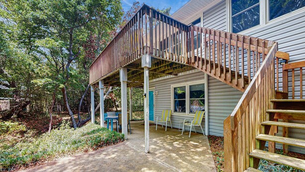 A wooden deck with a staircase leading to a covered porch area. - Perfect 3BR Getaway with Central A/C, Full Kitchen and Relaxing Balcony (Emerald Isle)