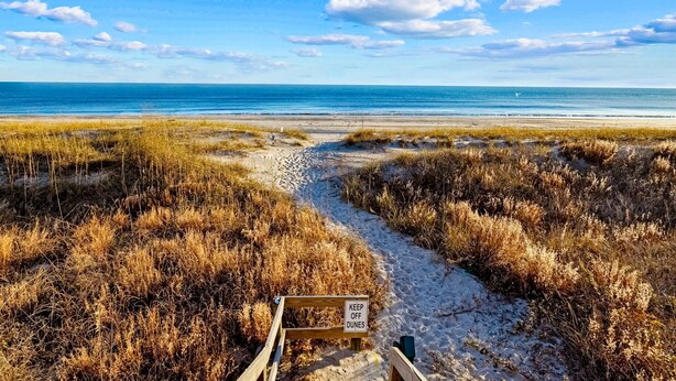 A beach path with a sign that reads "KEEP OFF DUNES." - Oceanfront condo with shared pool, beach access and ocean views (Atlantic Beach)