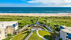A coastal hotel with a beach view, a central courtyard, and a boardwalk leading to the beach. - 2nd-floor condo with beach access, in/outdoor pools, hot tub, sports courts, AC (Atlantic Beach)