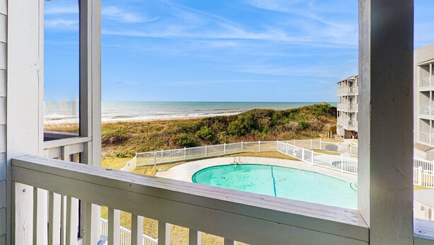 A pool with a view of the beach and ocean. - 2nd-Floor Condo in Oceanfront Location w/Shared Pool, Balcony, Free WiFi (Atlantic Beach)