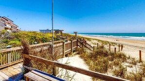A wooden boardwalk leading to a beach with a clear view of the ocean. - Beautiful 3rd-Floor Oceanfront Condow/Private Balcony & Shared Outdoor Pool (Pine Knoll Shores)
