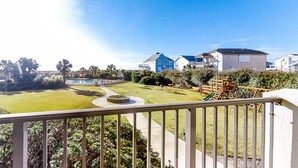 A residential area with houses, a playground, and a well-maintained lawn. - Wonderful condo with private washer/dryer, balcony, and pool/tennis (Atlantic Beach)