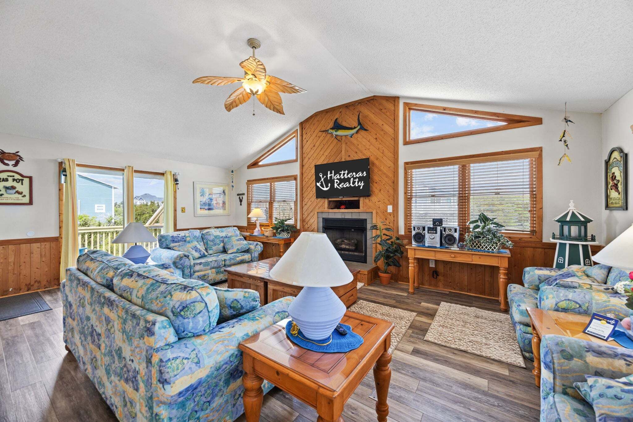A spacious living area with a fireplace, multiple seating options, and a view of the outdoors.
