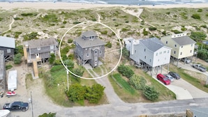A coastal residential area with houses, a beach, and a clear sky. - Gray Haven #11-DE: Oceanfront, dog-friendly, private hot tub, pool access (Avon)