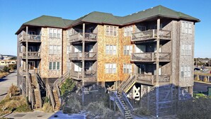 A multi-story building with wooden balconies and external staircases. - FKA Kimogener Point - ocean views, WiFi, W/D, balcony, pool & beach access (Avon)