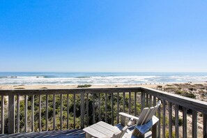 A wooden deck with a view of the ocean and beach. - Charming, Oceanfront Home w/Free WiFi, Private Hot Tub, W/D, and Shared Pool (Avon)