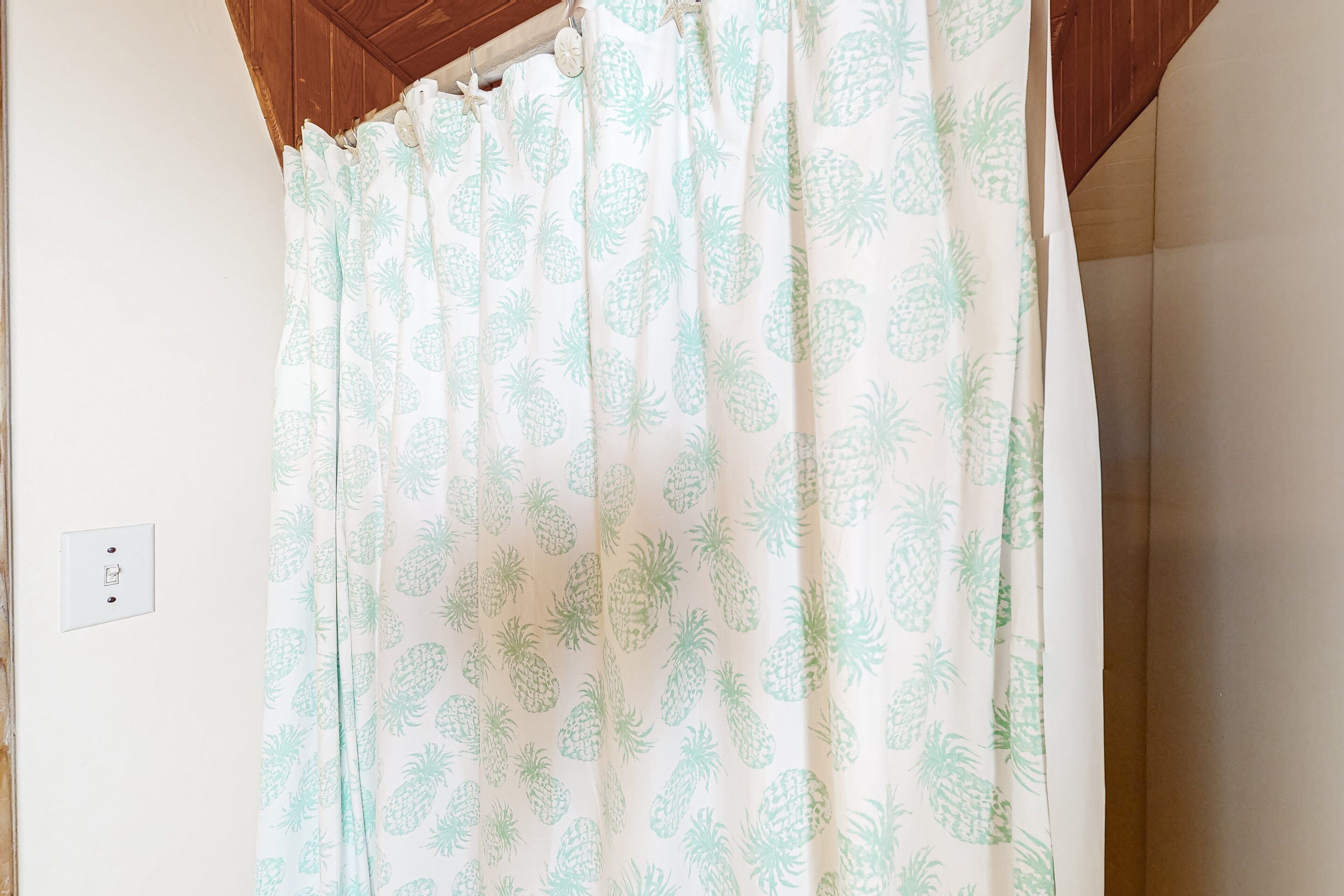 A shower curtain with a pineapple pattern.