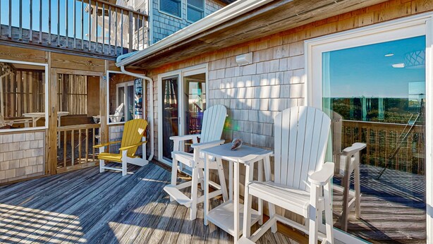 A wooden deck with white Adirondack chairs and a small table. - Sunset Park: Short Walk to the Beach, Great Views (Avon)