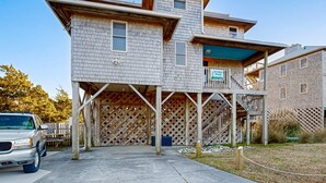 A two-story building with a covered outdoor area and a staircase leading to a second level. - Sunset Park: Short Walk to the Beach, Great Views (Avon)