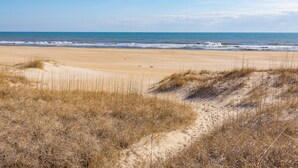 A beach with sand dunes and a clear view of the ocean. - Yankee Clipper 204: Oceanfront, balcony, ocean views (Avon)
