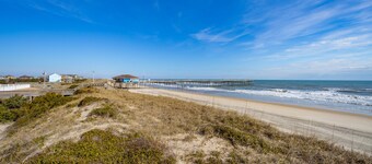 Fun-filled vacation home steps from beach with outdoor pool, AC, W/D, & balcony