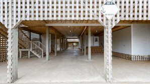 A covered outdoor area with wooden structures and a concrete floor. - Oceanfront home with central AC, ocean view, private hot tub, & pool (Avon)