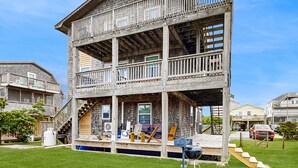 A two-story wooden house with a balcony, a staircase, and a front porch. - Tarpon Drive Hideaway B:Dog-friendly duplex w/Balcony (Avon)