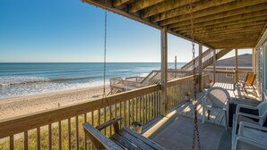 A wooden deck with a view of the beach and ocean. - Oceanfront home with ocean views, beach access, tanning deck & private elevator (Surf City)