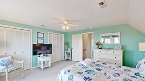 A bedroom with a bed, a TV, a dresser, and a chair. - Dog-friendly House w/Water View, Free WiFi, AC, Private Hot Tub (Frisco)