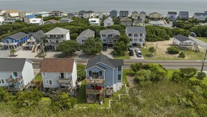 A coastal residential area with houses, a road, and a view of the ocean. - Stunning sound view home, close to the beach in the heart of Surf City (Surf City)