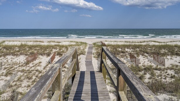 A wooden boardwalk leading to a beach with sand dunes and ocean views. - Beachfront home with stunning views, elevator and multiple decks (Topsail Beach)