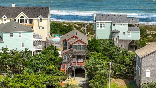A coastal residential area with houses, a beach, and ocean views. - Casablanca: Avon beach escape with themed suites, pool, hot tub & ocean views. (Avon)