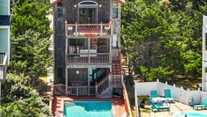 A multi-story building with a pool, balconies, and outdoor seating. - Casablanca: Avon beach escape with themed suites, pool, hot tub & ocean views. (Avon)