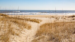 A beach with sand dunes and sparse vegetation. - Sea Escape 25: Beachfront, dog-friendly, private hot tub (Avon)