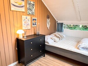 A bedroom with a bed, a dresser, wall art, and a ceiling fan. - 6 Person Holiday Home in Vaeggerlose (Vaeggerlose)