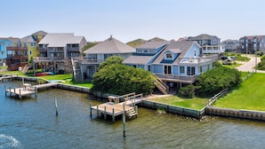 A waterfront residential area with houses, docks, and a grassy lawn. - Waterfront, Dog-Friendly House w/Shared Pool, Free WiFi, Private W/D, Central AC (Frisco)