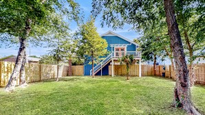 A blue house with a wooden deck and a staircase leading to a porch. - Dog friendly coastal retreat with short walk to the beach and enclosed yard (Carolina Beach)