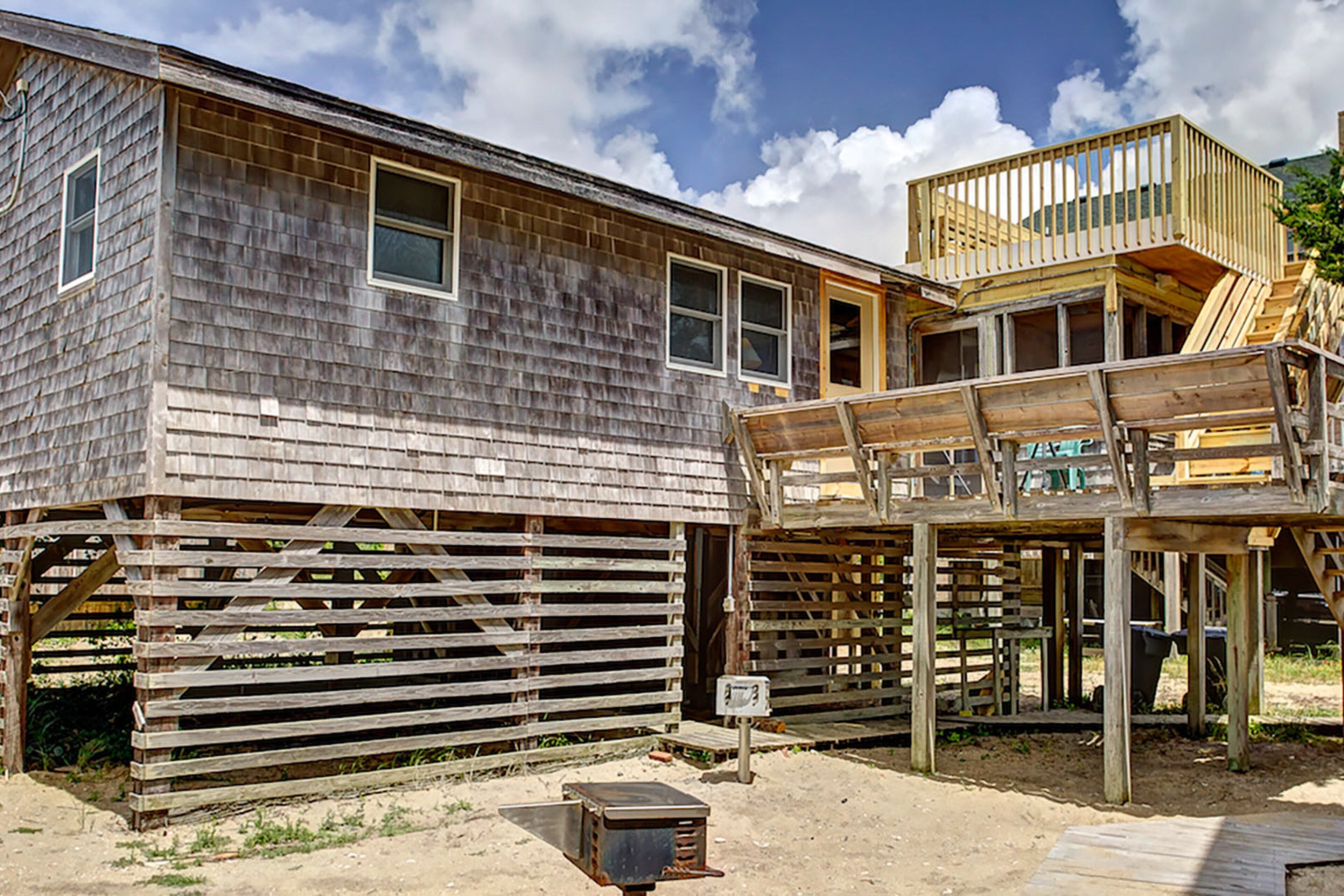 A rustic wooden building with multiple windows and a wooden deck.
