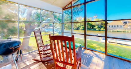 Waterfront home on a scenic canal with a dock, screened porch & fast WiFi