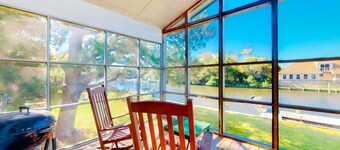 Waterfront home on a scenic canal with a dock, screened porch & fast WiFi