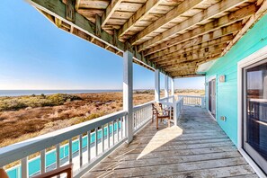 A wooden deck with a view of the beach and ocean. - Sound front home with amazing views, private pool, hot tub, theater & rec room (Avon)