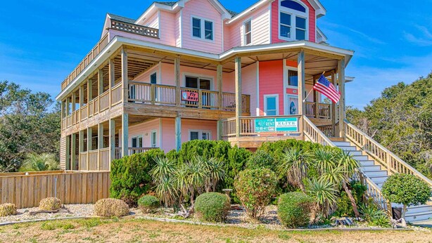 A two-story house with a balcony, a staircase, and a flag. - 3-story luxury home with pool, hot tub, AC, tennis, & deck - dog-friendly (Avon)