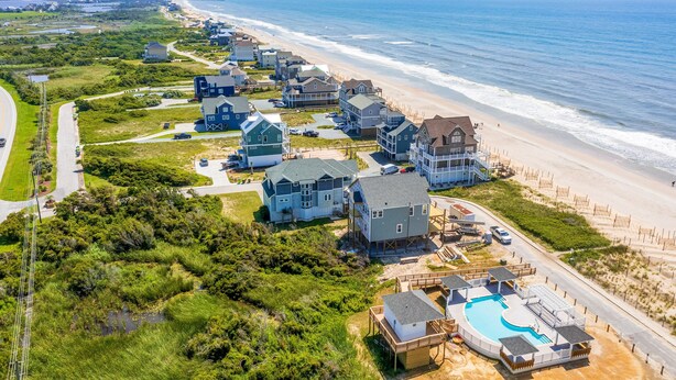 A coastal residential area with houses, a beach, and a swimming pool. - Spacious, dog-friendly home with ocean views, beach access, & pool (North Topsail Beach)