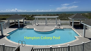 A pool with a view of the ocean, surrounded by wooden decks and gazebos. - Spacious, dog-friendly home with ocean views, beach access, & pool (North Topsail Beach)