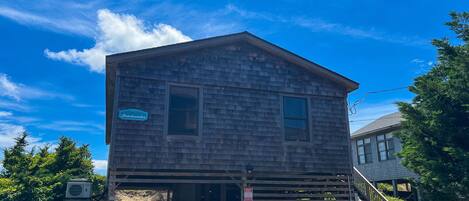 A two-story wooden building with a sign reading 'Welcome to Beachcomber.'