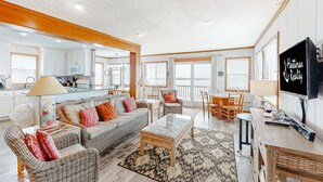 A spacious living room with a sofa set, a coffee table, and a TV.