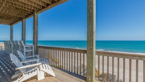 A wooden deck with beach chairs overlooking the ocean. - Beachfront, multi-level home with pool, beach access & private hot tub (North Topsail Beach)