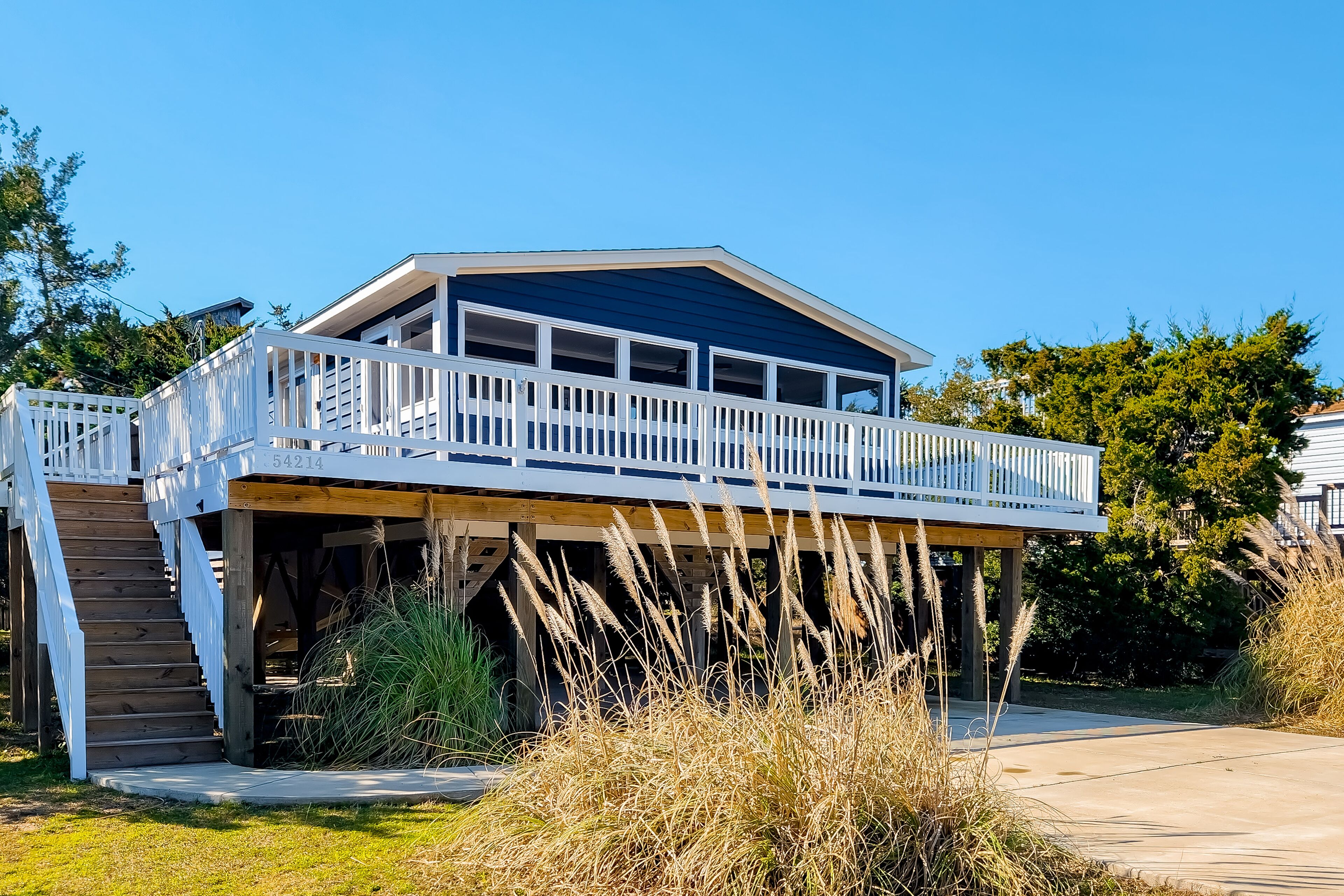 A house with a wooden deck and a balcony.