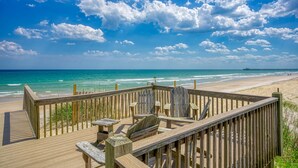 A wooden deck with benches and tables overlooking a beach and ocean. - Oceanfront home with beach access, washer/dryer, central AC & golf nearby (North Topsail Beach)