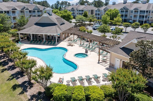 Golf community condo near beach with on-site pool, golf, & screened balcony