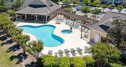 Golf community condo near beach with on-site pool, golf, & screened balcony