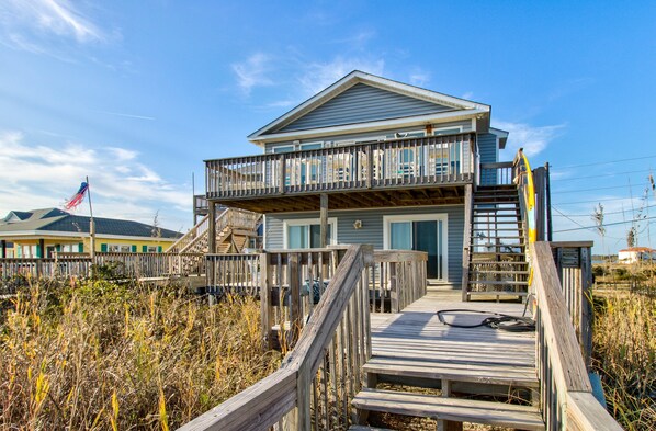 A two-story beach house with a wooden deck and a balcony. - Multi-level ocean view home with two decks, a washer/dryer & beach access (North Topsail Beach)