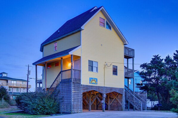 A two-story building with a balcony and a wooden deck. - Sandy Paws 394: Stunning Views, Pool Access, Pet-Friendly (Avon)