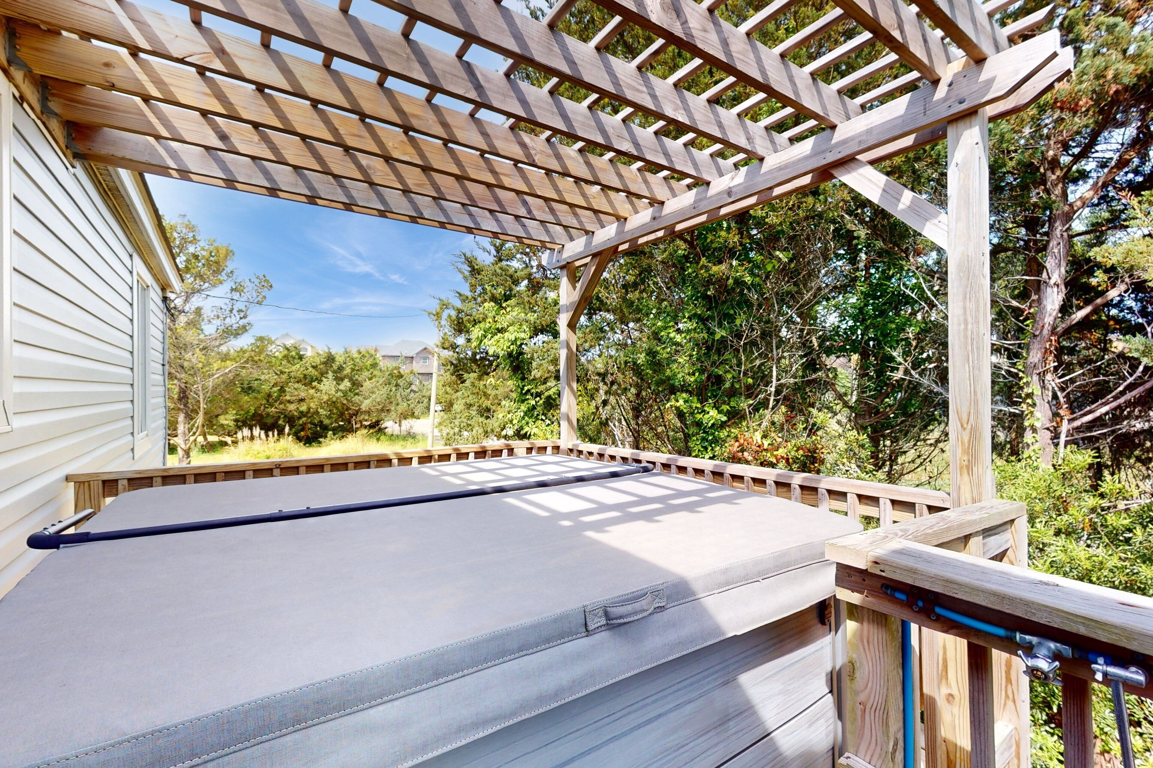 A covered outdoor deck with a pool table.