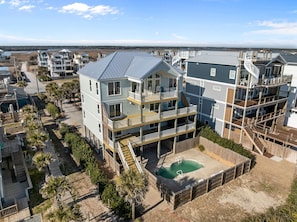 A multi-story residential building with a rooftop pool and multiple balconies.