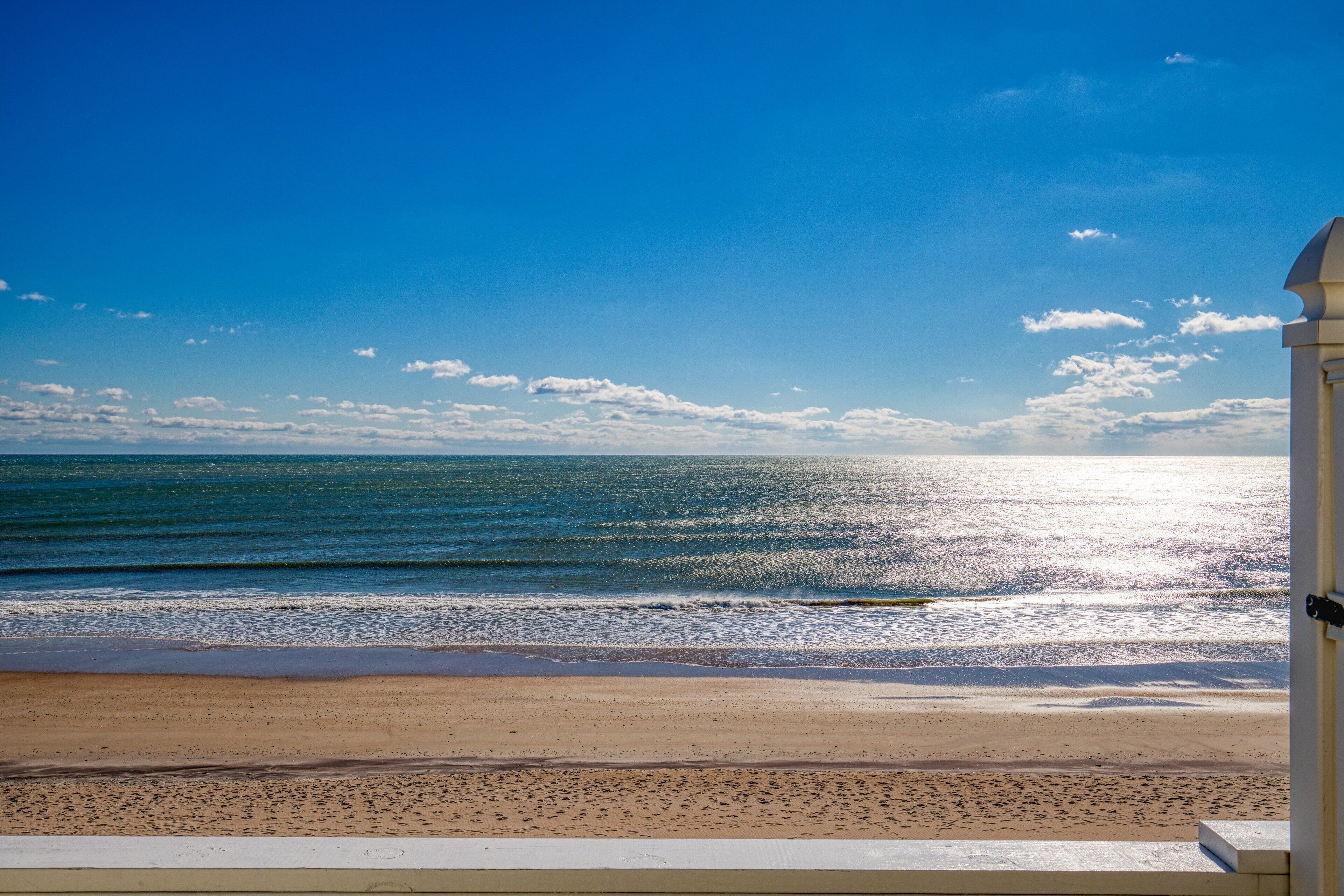 A beach view with a clear sky and calm sea.