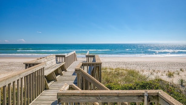 A wooden boardwalk leading to a beach with a clear view of the ocean. - Oceanfront duplex with 4 decks, private beach walkway, central AC, & W/D (North Topsail Beach)