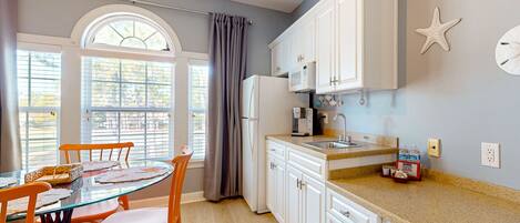 Fridge, microwave, coffee/tea maker, cookware/dishes/utensils