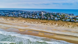 A coastal town with beachfront properties and a beach in the foreground. - Spacious dog-friendly house with shared pool, private hot tub, & central AC (Avon)