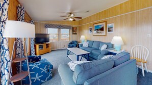 A cozy living room with a sofa set, a television, and a ceiling fan. - Spacious dog-friendly house with shared pool, private hot tub, & central AC (Avon)